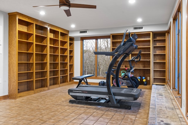 exercise area featuring tile patterned floors and ceiling fan