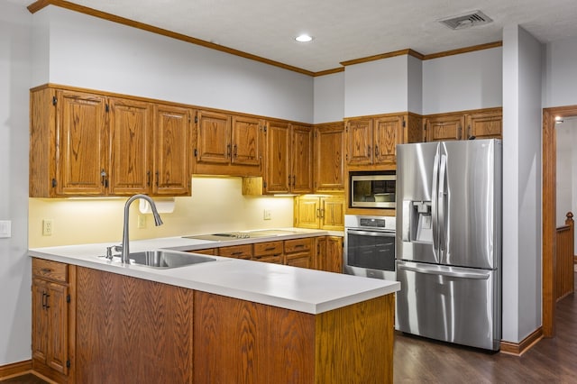 kitchen featuring sink, dark hardwood / wood-style floors, ornamental molding, kitchen peninsula, and stainless steel appliances