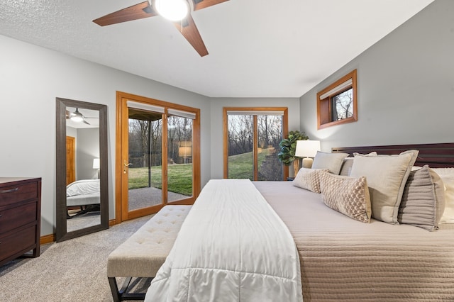 carpeted bedroom featuring access to exterior, ceiling fan, and a textured ceiling