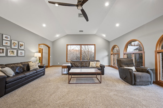 carpeted living room with ceiling fan and lofted ceiling