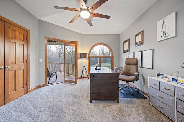 office with ceiling fan, dark carpet, and a textured ceiling