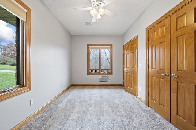 bedroom featuring ceiling fan, light carpet, and a textured ceiling