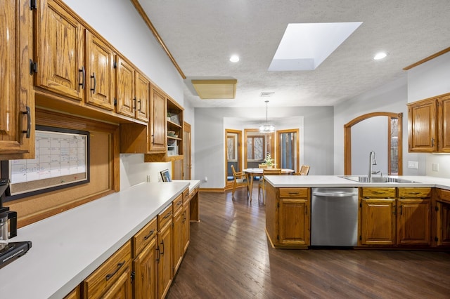 kitchen featuring pendant lighting, a textured ceiling, dark hardwood / wood-style floors, and stainless steel dishwasher