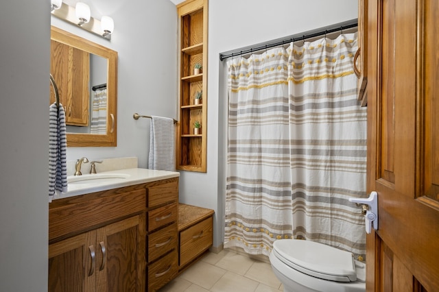 bathroom featuring tile patterned flooring, vanity, and toilet