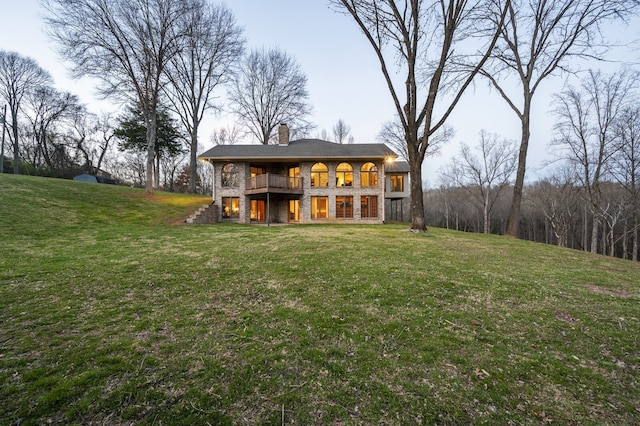 rear view of house featuring a lawn