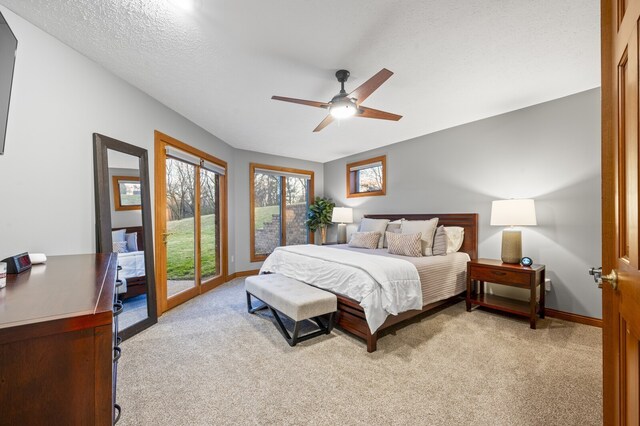 carpeted bedroom with access to exterior, ceiling fan, and a textured ceiling