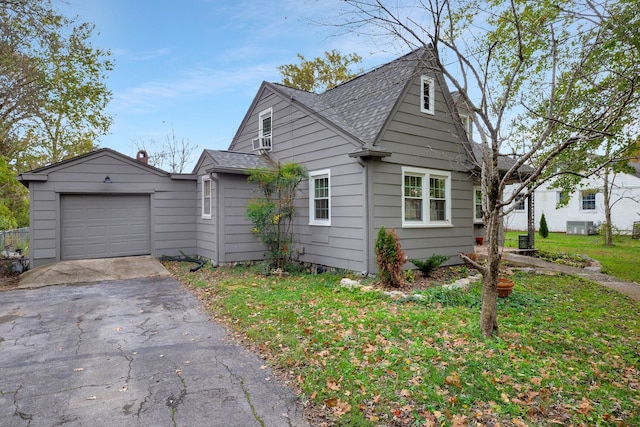 bungalow with cooling unit and a garage