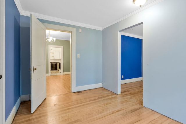 empty room with light hardwood / wood-style floors and ornamental molding