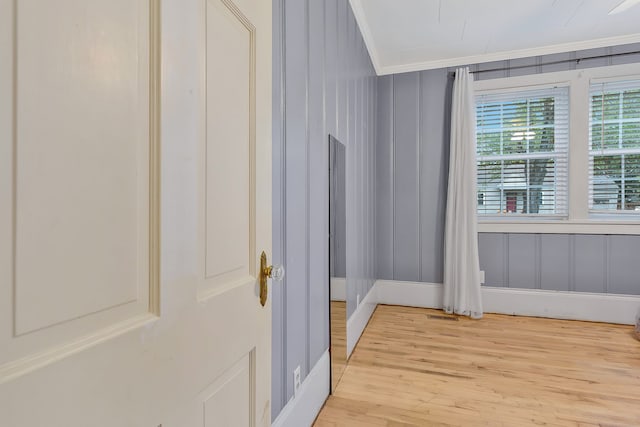 interior space with hardwood / wood-style flooring and ornamental molding