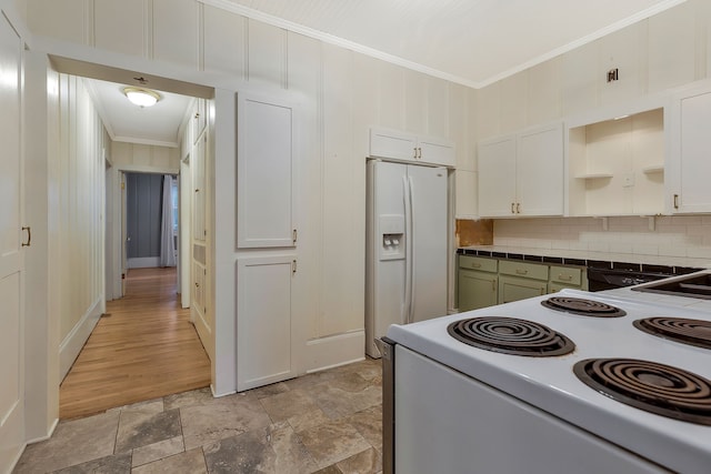 kitchen featuring white cabinets, decorative backsplash, and white appliances