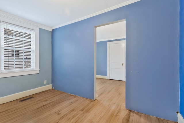 spare room with light hardwood / wood-style flooring and ornamental molding