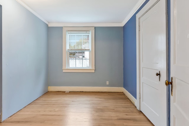 unfurnished room featuring light hardwood / wood-style floors and ornamental molding