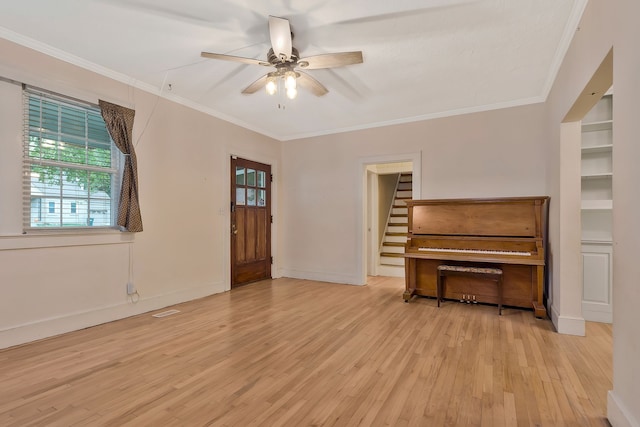 unfurnished living room with light hardwood / wood-style flooring, ceiling fan, and ornamental molding