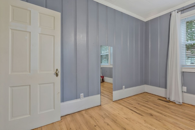 unfurnished bedroom with crown molding and light hardwood / wood-style flooring