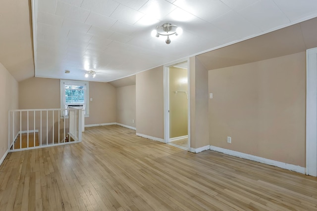 interior space featuring lofted ceiling and light hardwood / wood-style flooring