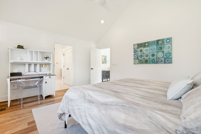 bedroom with high vaulted ceiling and light hardwood / wood-style flooring