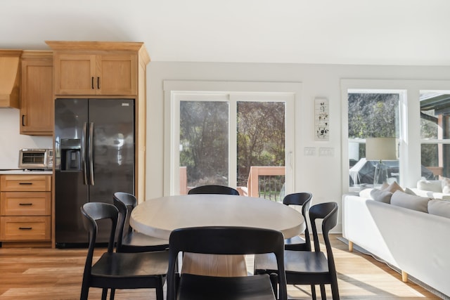 dining space featuring light wood-type flooring