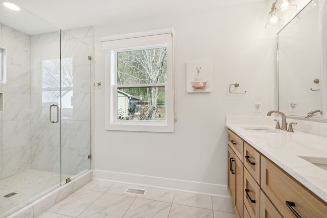 bathroom with vanity and a shower with shower door