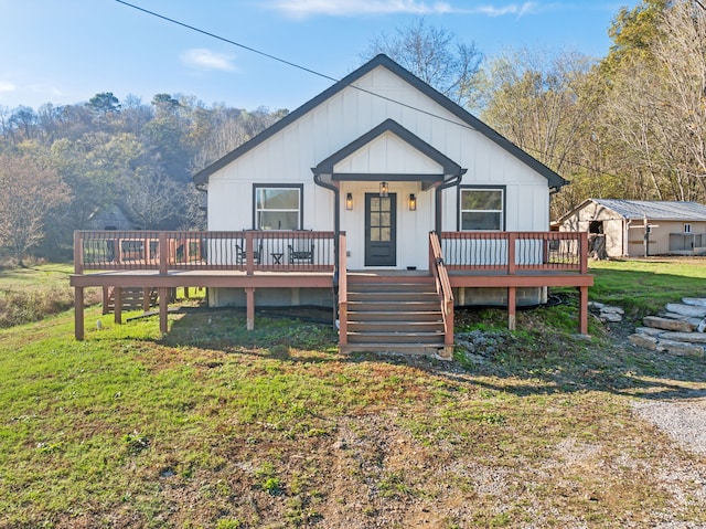 view of front of house featuring a front yard and a deck