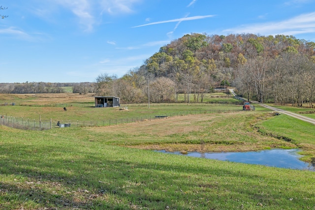 view of yard featuring a rural view and a water view