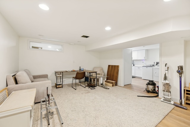 interior space featuring washer and dryer and light wood-type flooring