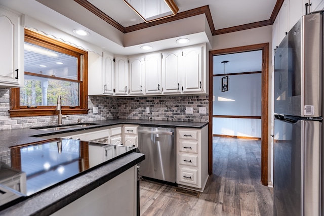 kitchen featuring white cabinets, crown molding, sink, dark hardwood / wood-style floors, and appliances with stainless steel finishes