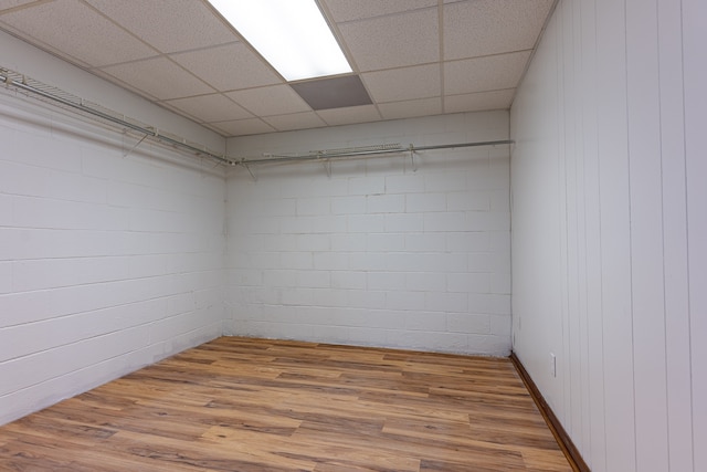 spare room featuring a paneled ceiling and wood-type flooring