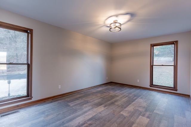 unfurnished room featuring dark hardwood / wood-style flooring