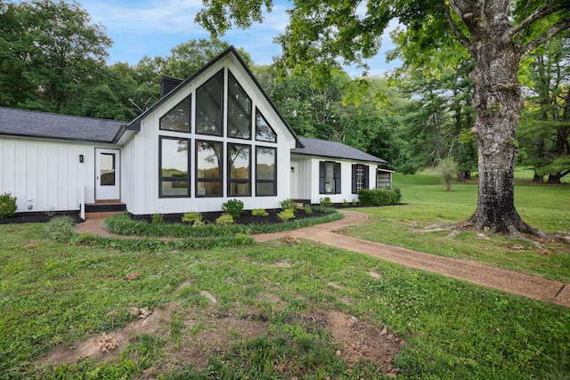 rear view of house with a yard