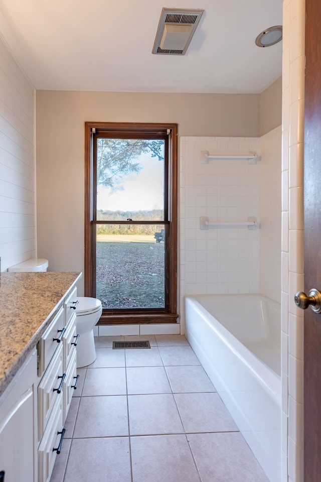 bathroom featuring tile patterned floors, vanity, and toilet