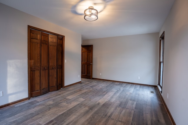 unfurnished bedroom featuring hardwood / wood-style floors and a closet