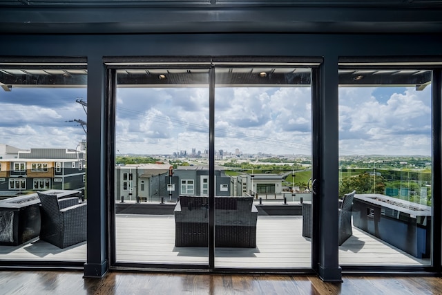 doorway to outside with a city view and wood finished floors