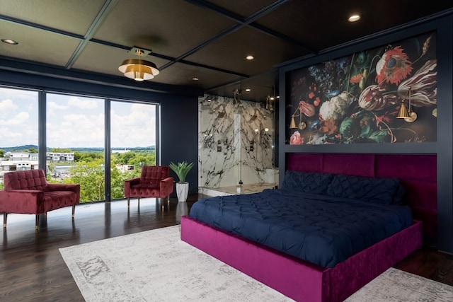 bedroom with coffered ceiling and dark wood-style flooring