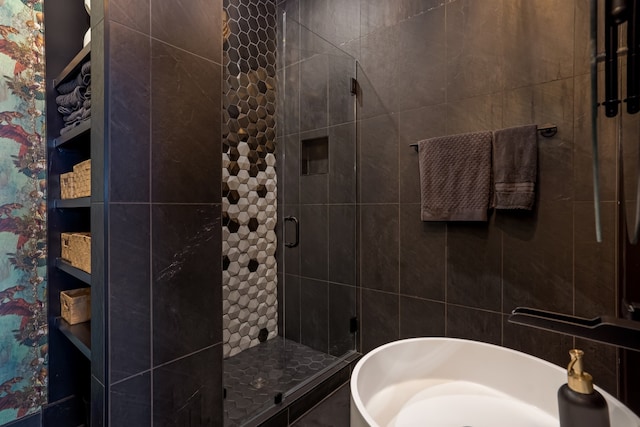 bathroom featuring a stall shower and a sink