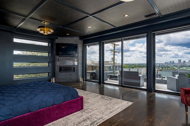 bedroom featuring access to exterior, coffered ceiling, dark wood finished floors, and visible vents