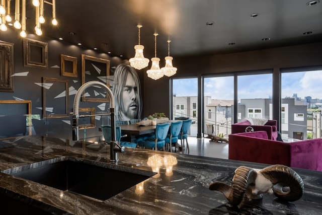 kitchen with a view of city, open floor plan, decorative light fixtures, and a sink