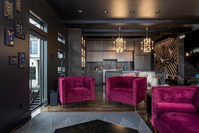 living area with dark wood-style floors and a notable chandelier