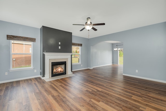 unfurnished living room featuring ceiling fan and dark hardwood / wood-style flooring