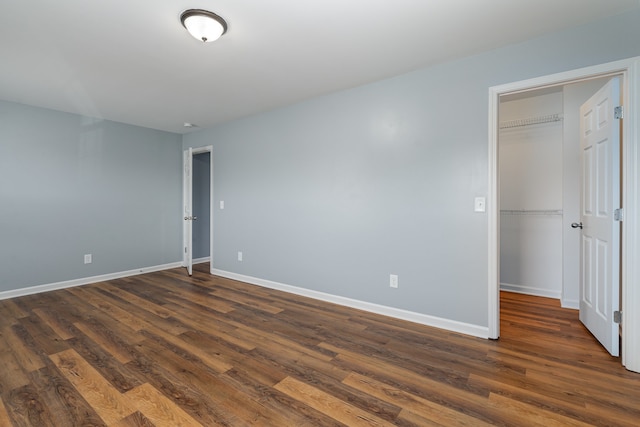 unfurnished room with dark hardwood / wood-style floors