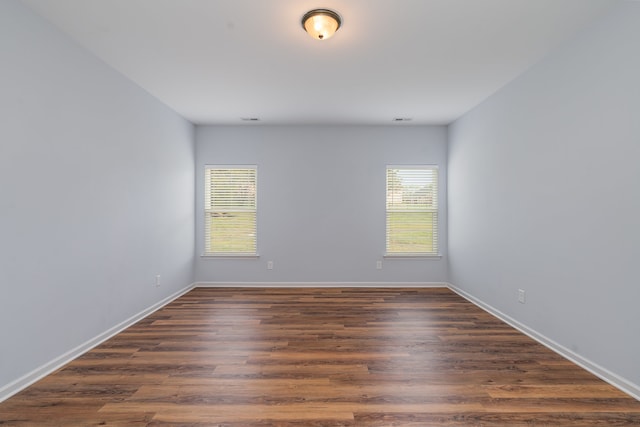 unfurnished room featuring dark hardwood / wood-style floors