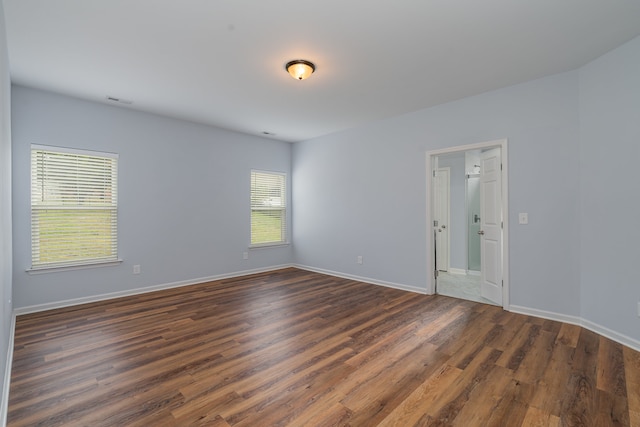 spare room featuring dark wood-type flooring