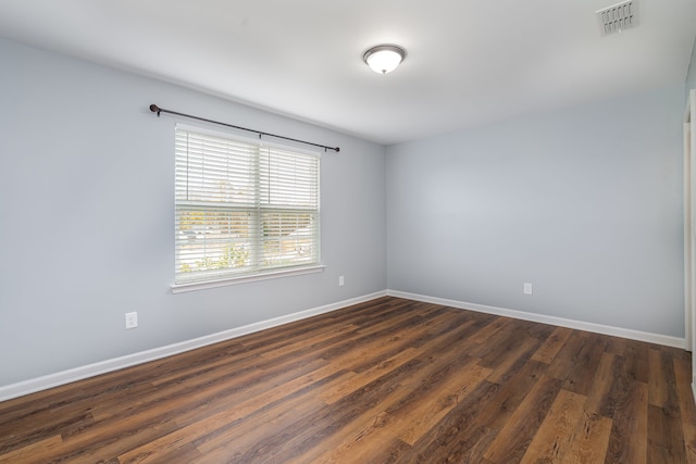 spare room featuring dark hardwood / wood-style flooring