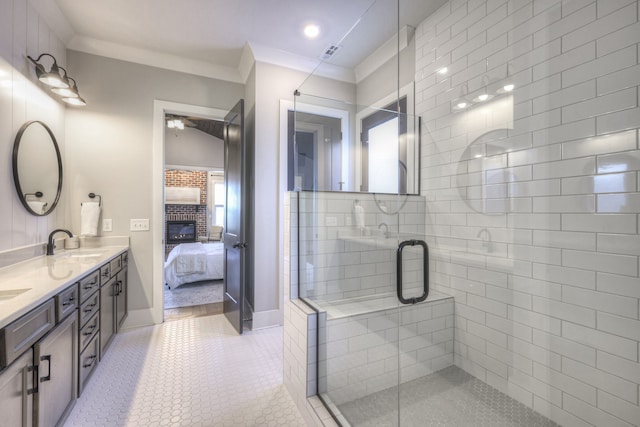 bathroom featuring tile patterned floors, a brick fireplace, ornamental molding, vanity, and a shower with door