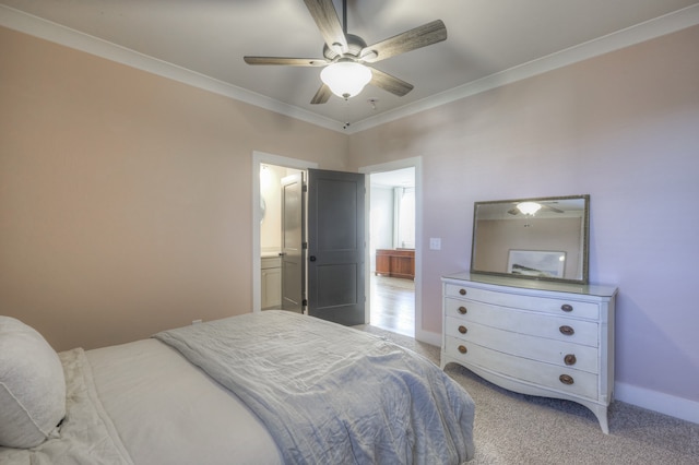 bedroom featuring carpet, ceiling fan, ensuite bathroom, and crown molding