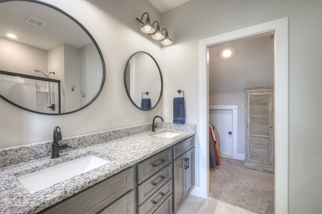 bathroom featuring tile patterned floors, vanity, and a shower with shower door