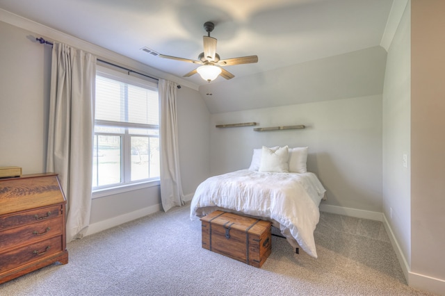 bedroom with ceiling fan, light colored carpet, and vaulted ceiling