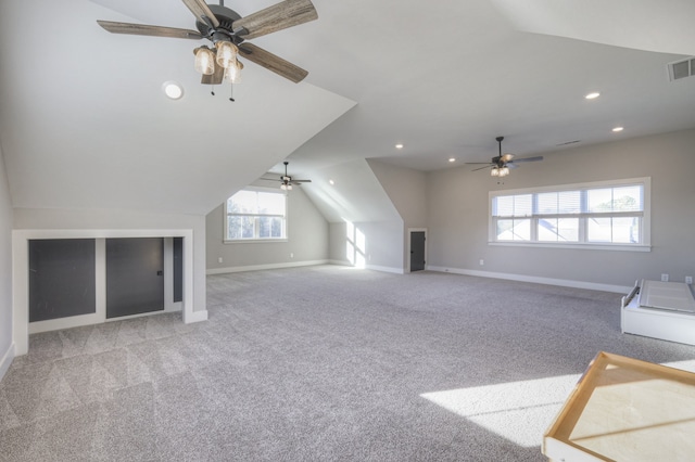 additional living space with light colored carpet, vaulted ceiling, and ceiling fan