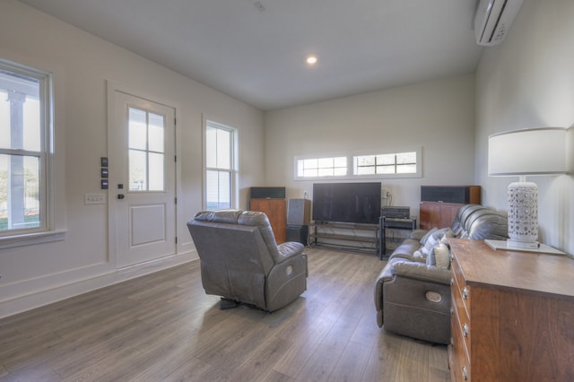 living room featuring hardwood / wood-style floors and a wall mounted AC