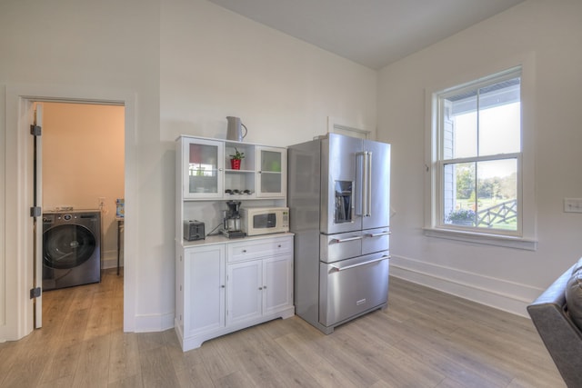 kitchen featuring washer / clothes dryer, light hardwood / wood-style flooring, and high end fridge