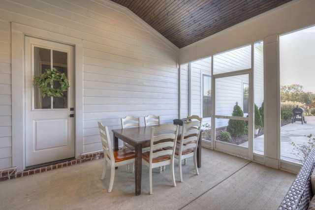 sunroom / solarium featuring wooden ceiling and vaulted ceiling